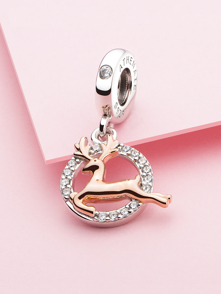 Golden reindeer pendant charm styled on charm bracelet