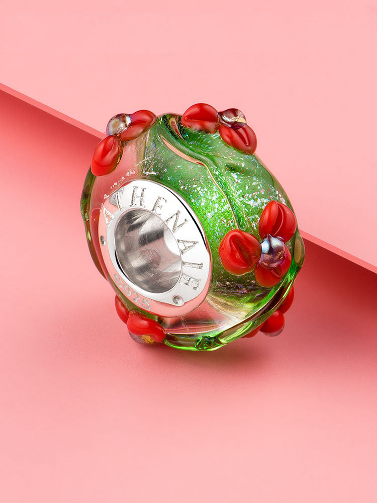 Close-up of the green Murano glass bead with red flowers