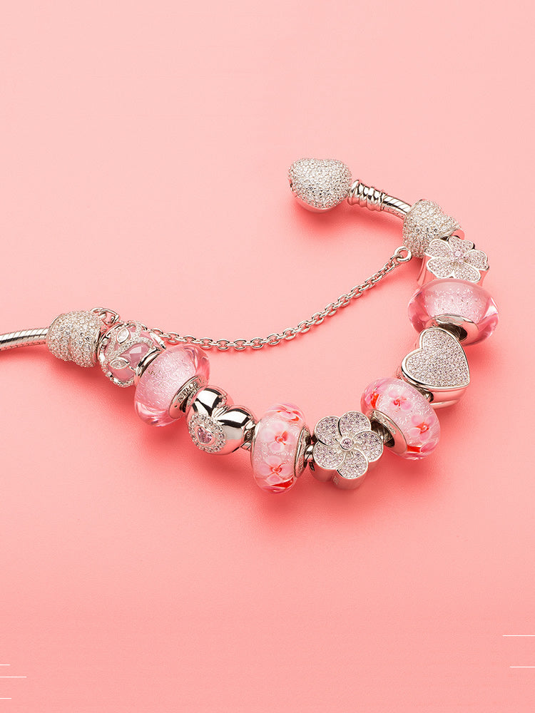 Sparkling heart charm styled with silver charm bracelet by ATHENAIE