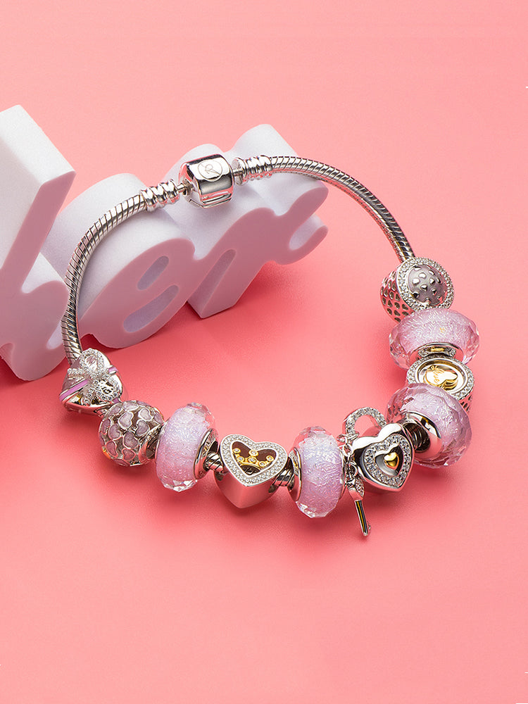 Gold heart charm styled with sterling silver charm bracelet by ATHENAIE