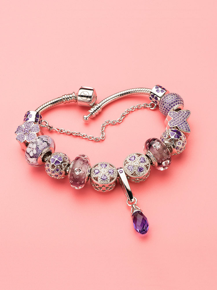 Lavender whisper murano glass charm displayed on sterling silver bracelet