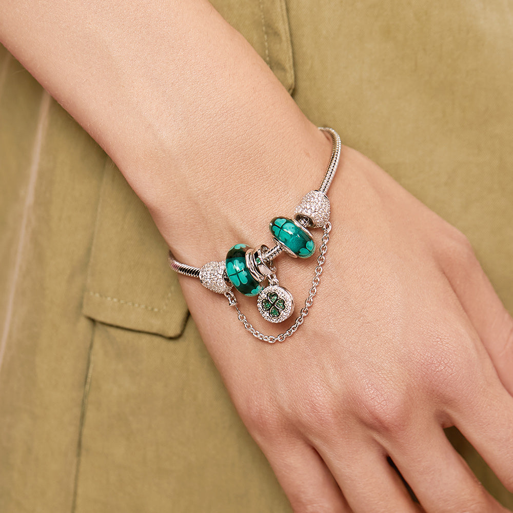 Close-up of Lucky Clover Murano glass charm bead on model’s wrist.