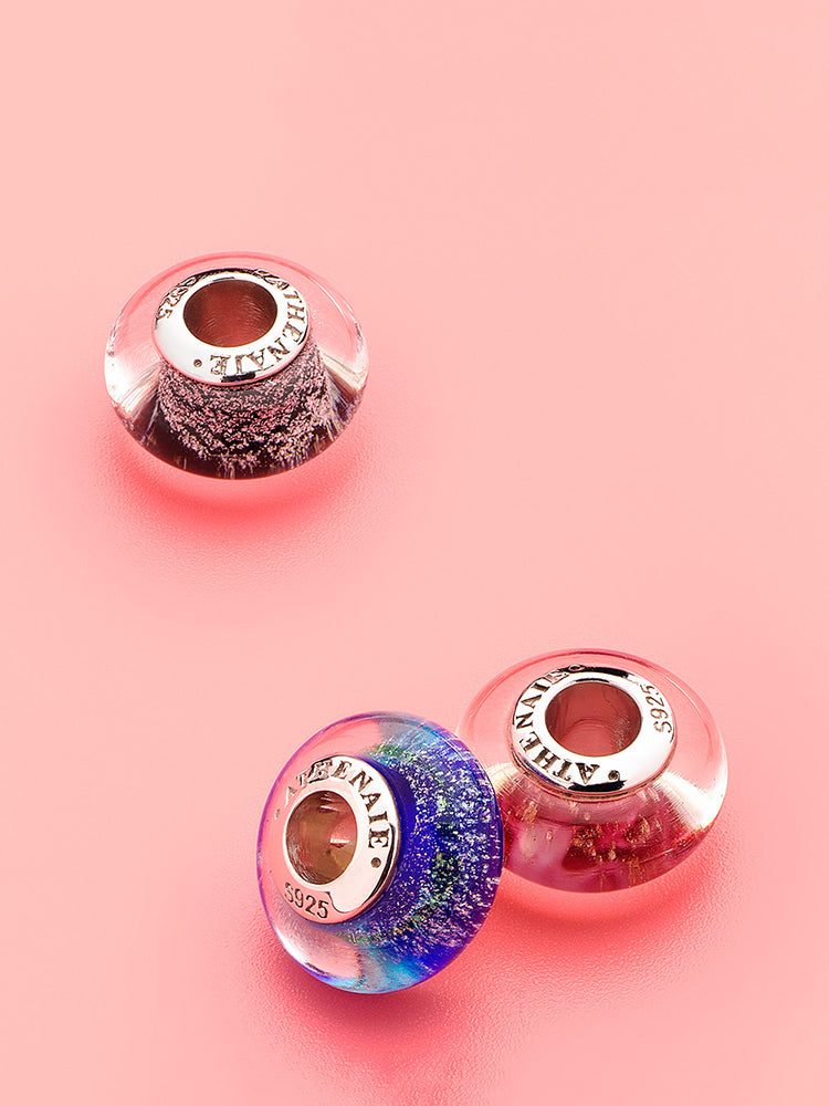 Midnight lagoon murano glass charm styled on silver charm bracelet