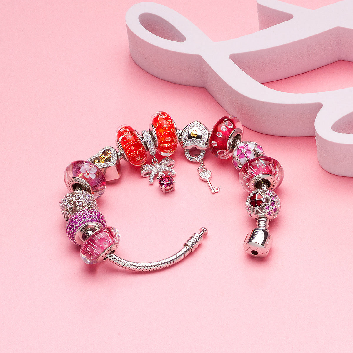 Elegant bracelet set featuring red Murano glass charm Rosy Glow
