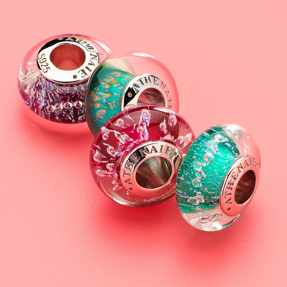 Rosy Glow red Murano glass charm styled on bracelet