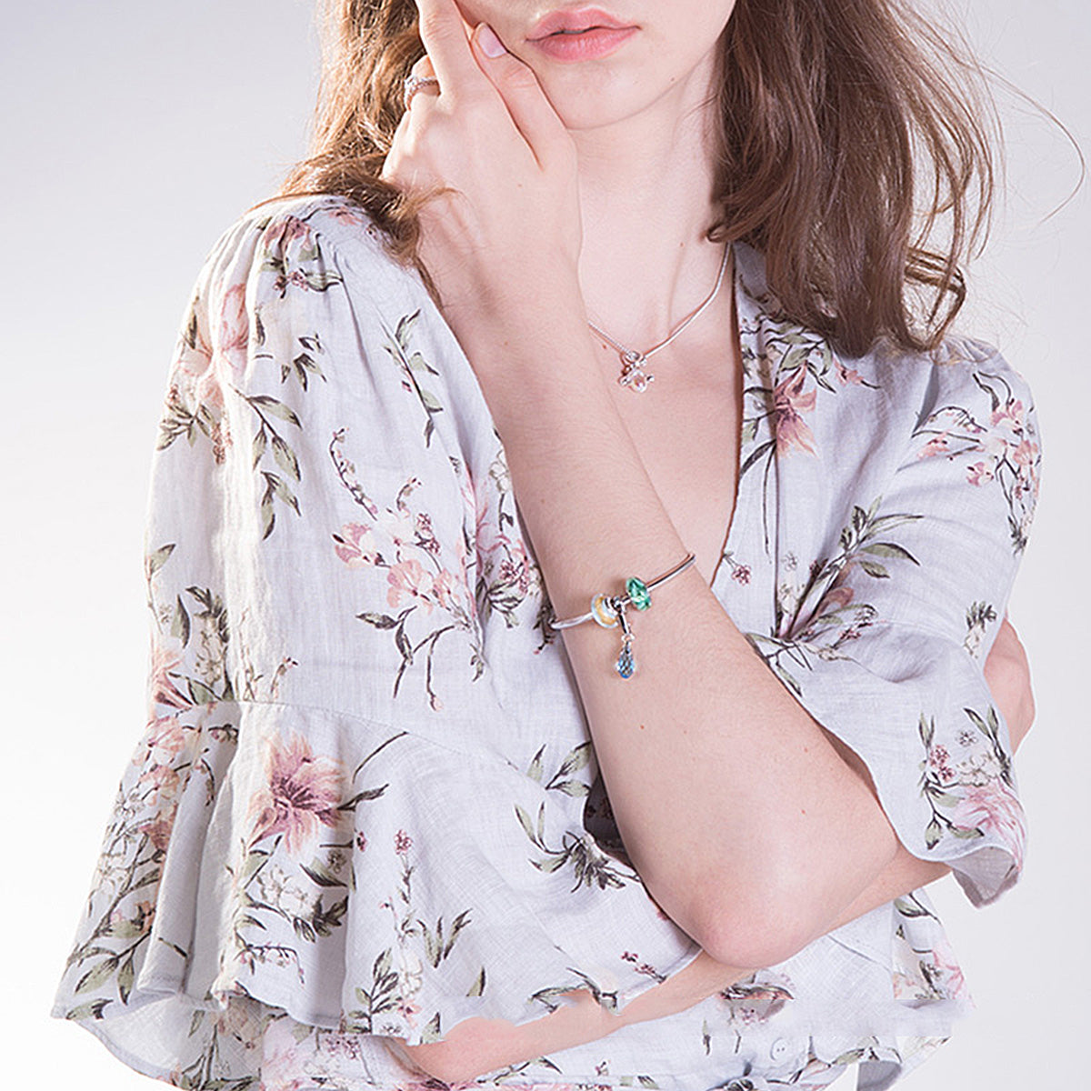 Woman wearing Forest Leaf Murano Glass Charm on bracelet