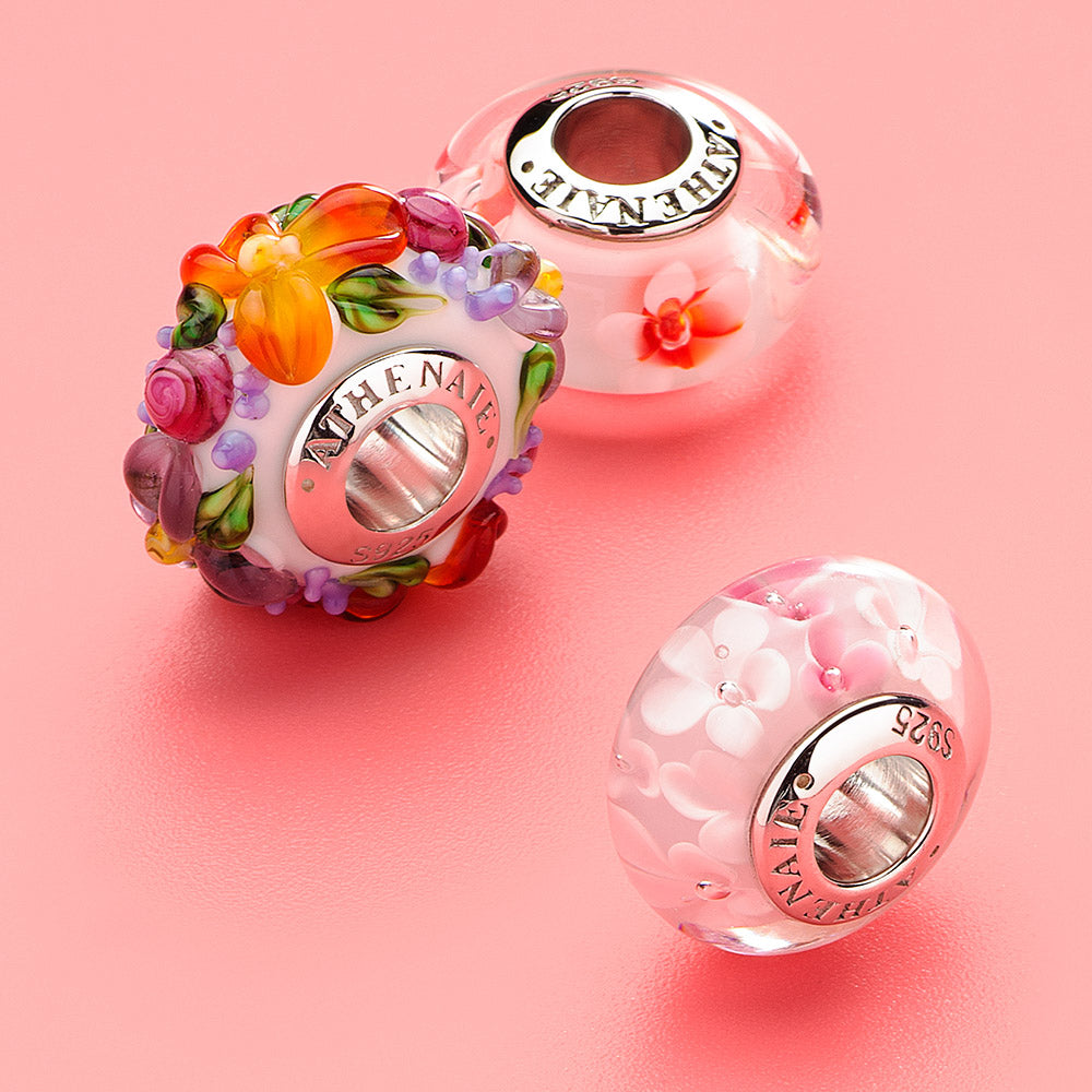 Murano glass cherry blossom charm glowing in natural light