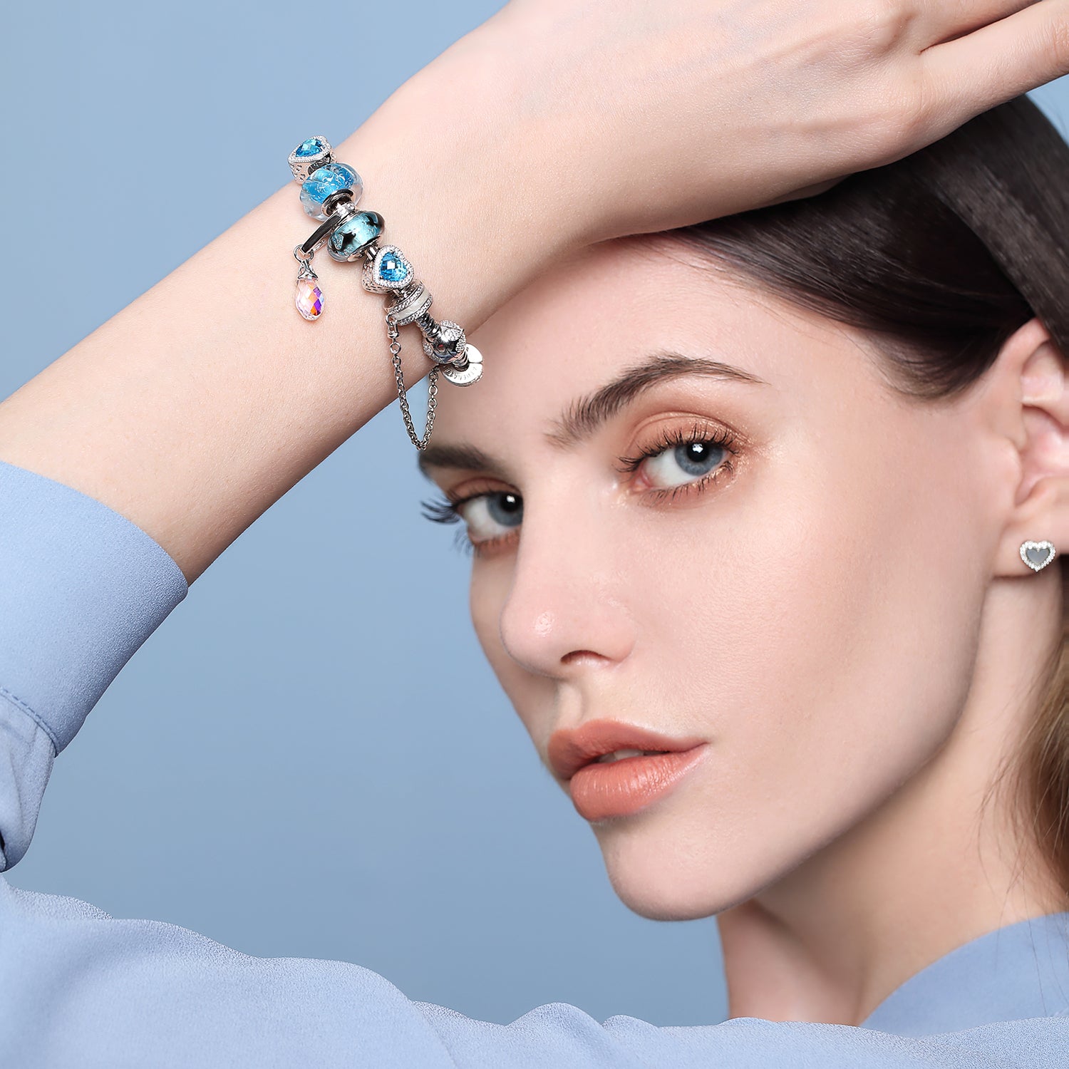 Close-up of model wearing Silent Bond safety chain charm on bracelet