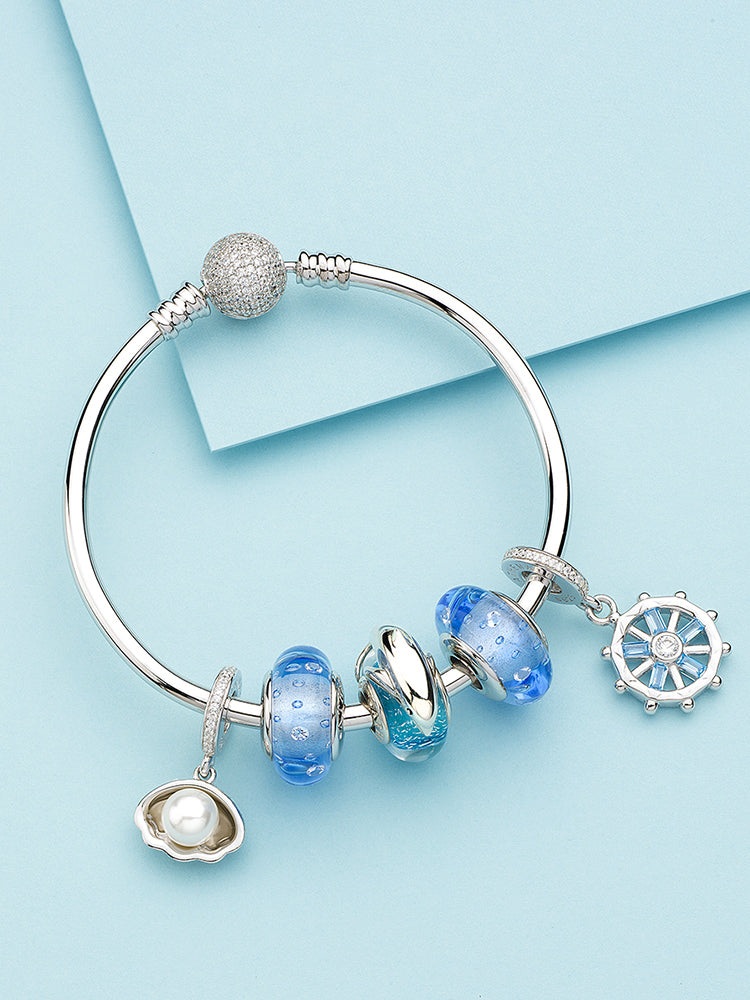 Murano glass charm bracelet styling with blue bead