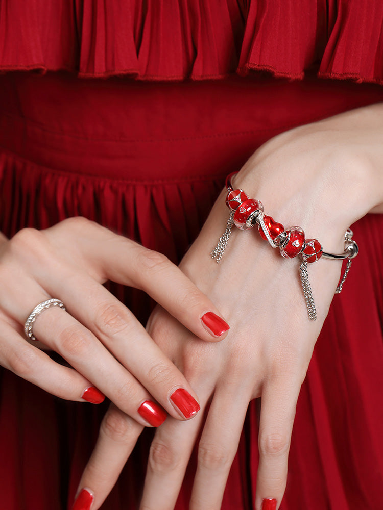 Murano glass charm bead with crimson heart worn on bracelet