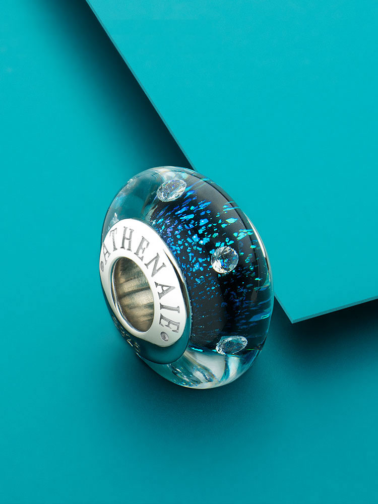 Blue starlight murano glass charm styled on bracelet