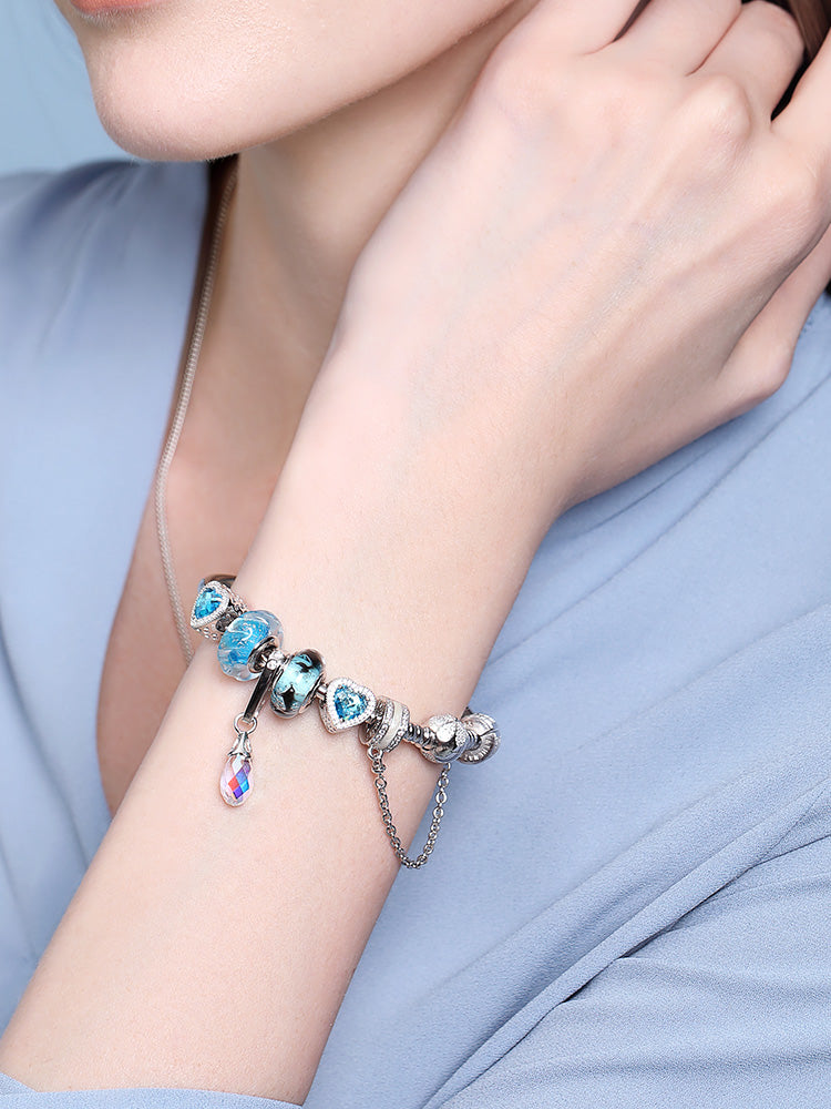 Ocean Breath Murano glass bead charm styled on bracelet worn by model