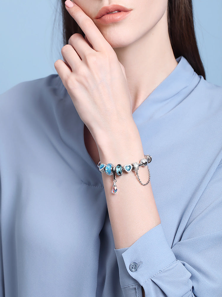 Ocean Breath Murano glass bead charm worn on bracelet by model