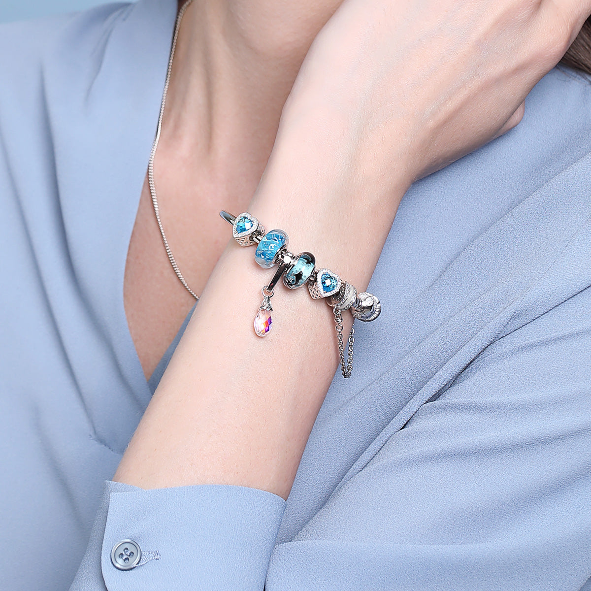 Model wearing Ocean Breath Murano glass charm, elegant and ocean-inspired bracelet styling