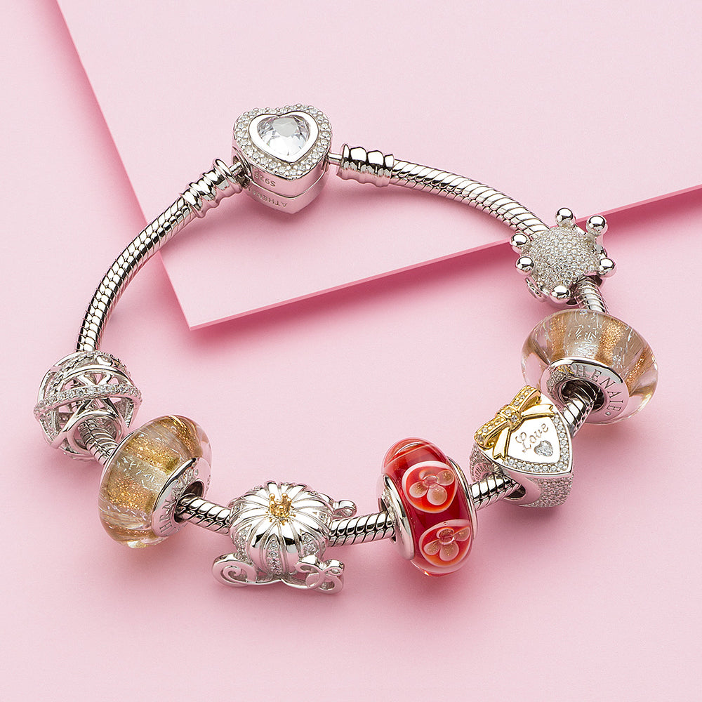 Sparkling crown charm styled with matching silver bracelet