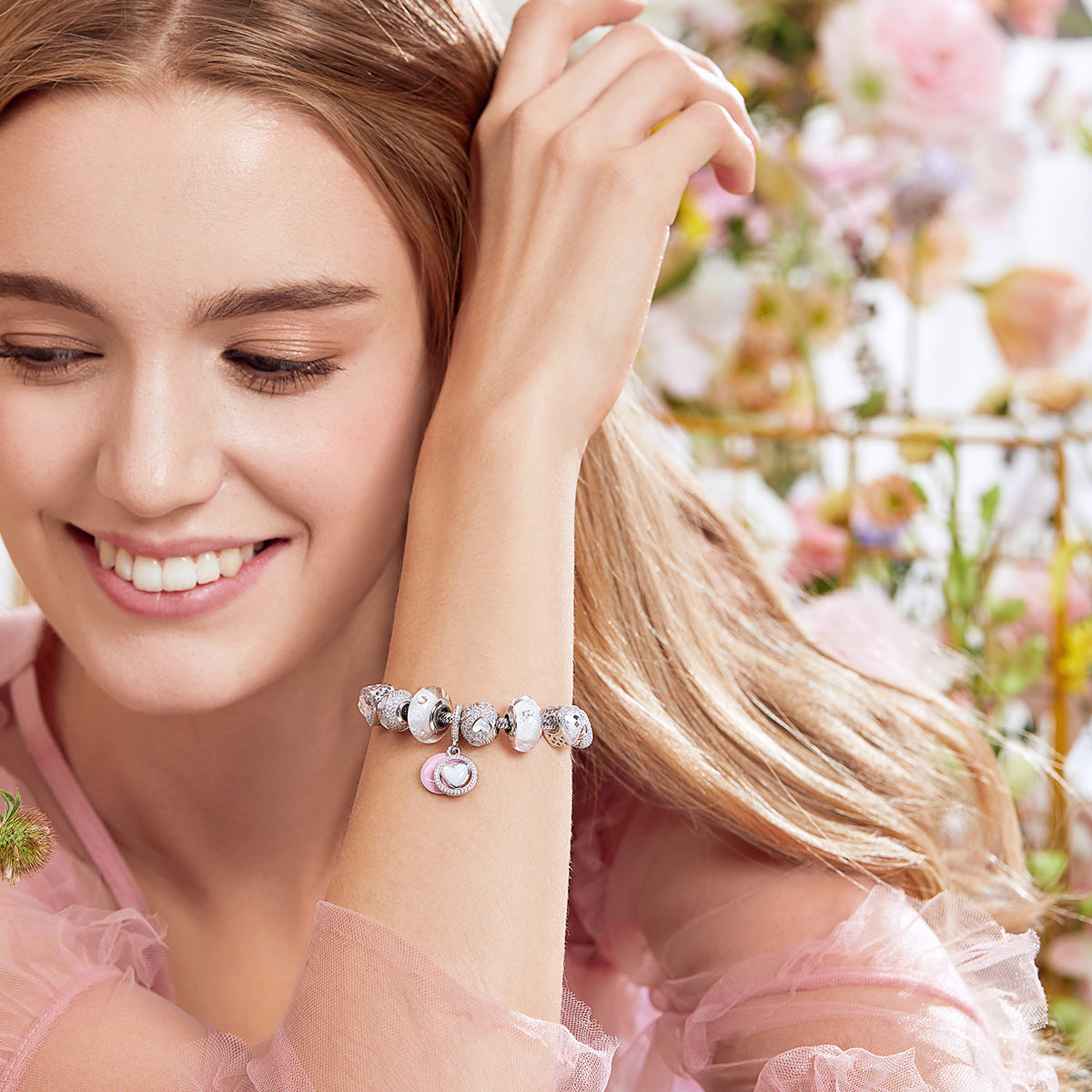 Lifestyle image of woman wearing Mother’s Heart charm with CZ and pearl