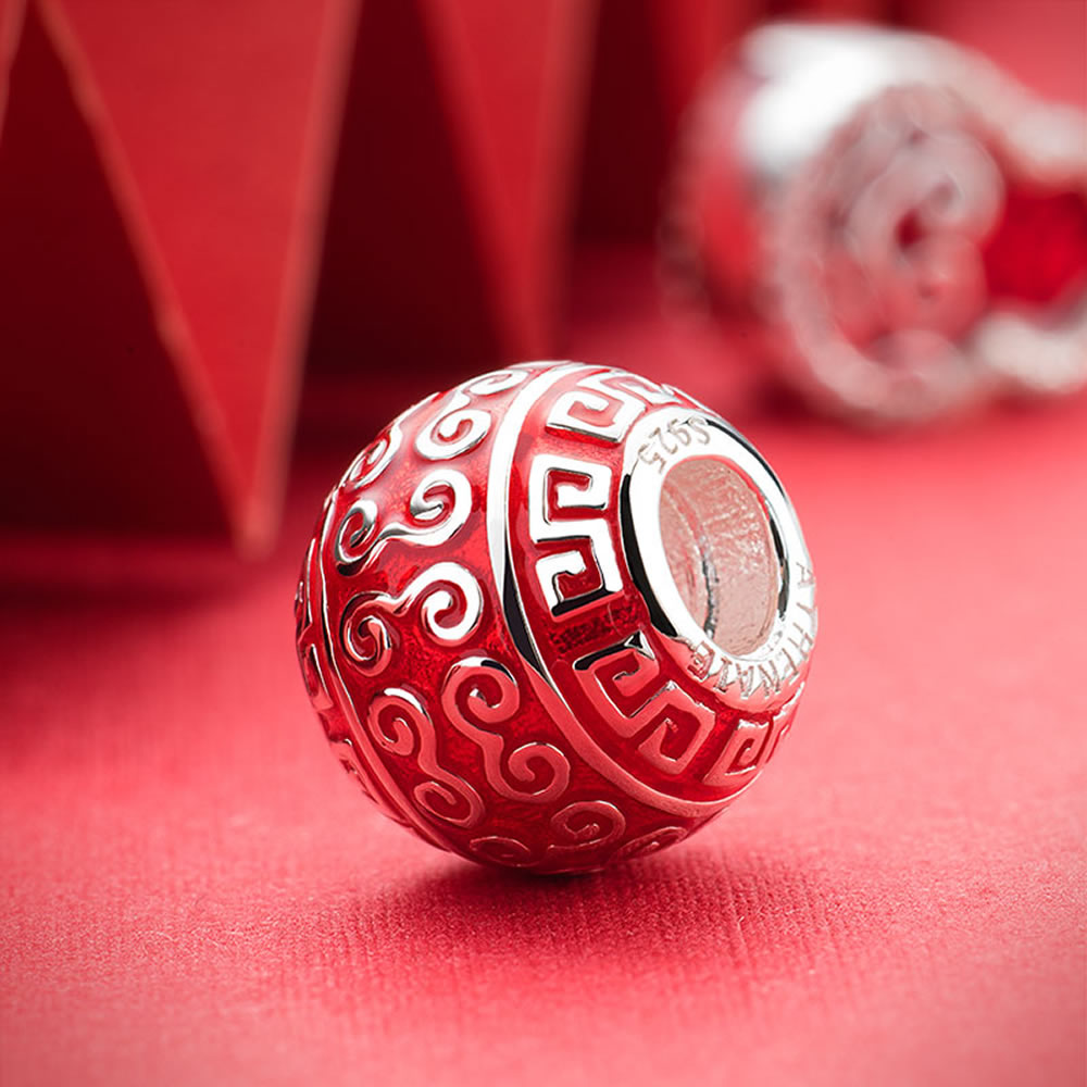 Peaceful Luck 925 silver enamel charm bead displayed in festive scene.
