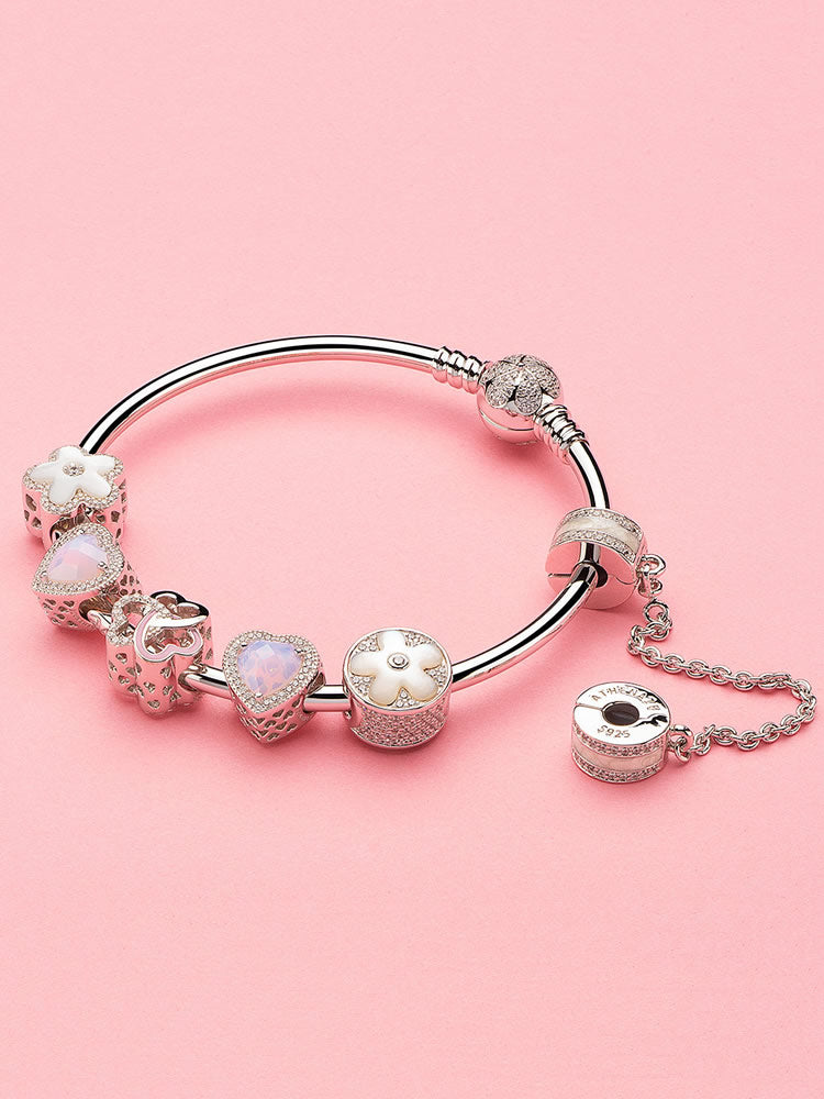 Peach blossom charm on a silver charm bracelet