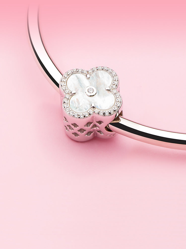 Pearl Clover charm bead displayed on silver charm bracelet