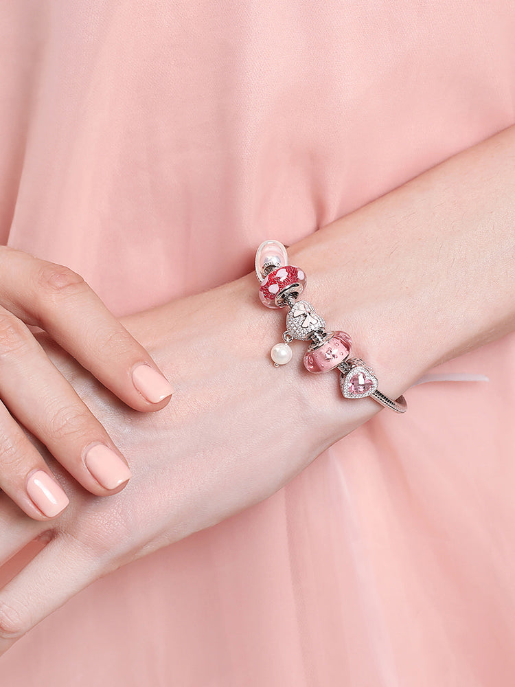 Model wearing pearl bow heart charm bead bracelet