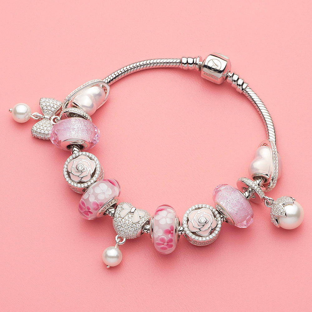 Petal Pearl charm pendant paired with floral-themed charms on sterling silver bracelet, elegant feminine gift idea