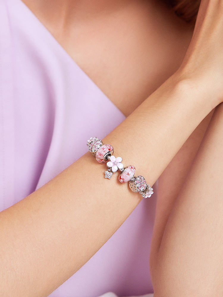 Pink charm bead bracelet worn on model wrist