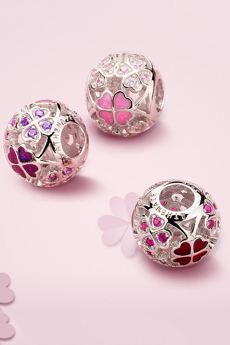 Charm bracelet styling with pink enamel shamrock charm bead