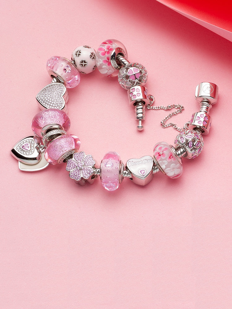 Sterling silver charm bracelet with pink enamel shamrock charm bead