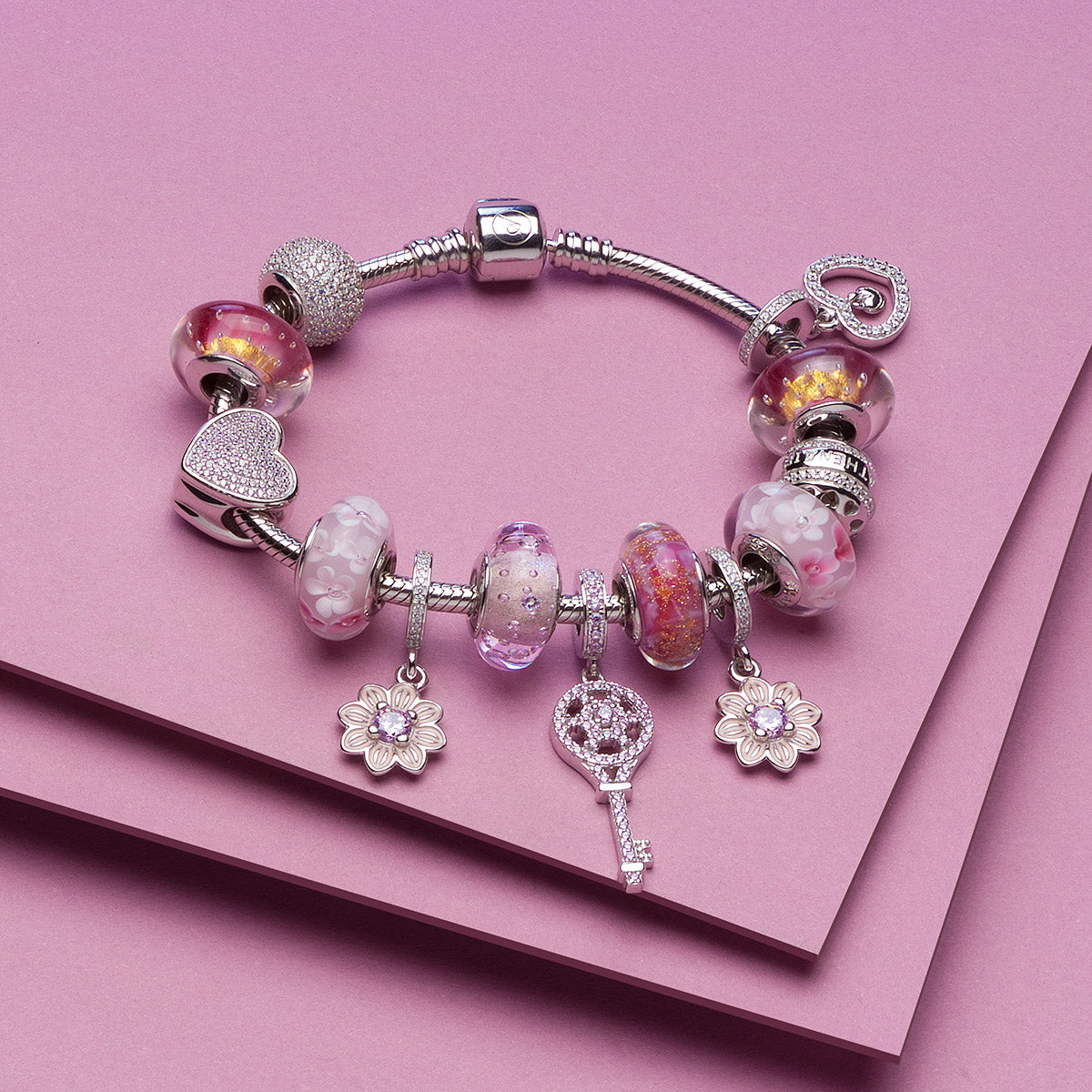 Heart charm styled with classic silver charm bracelet