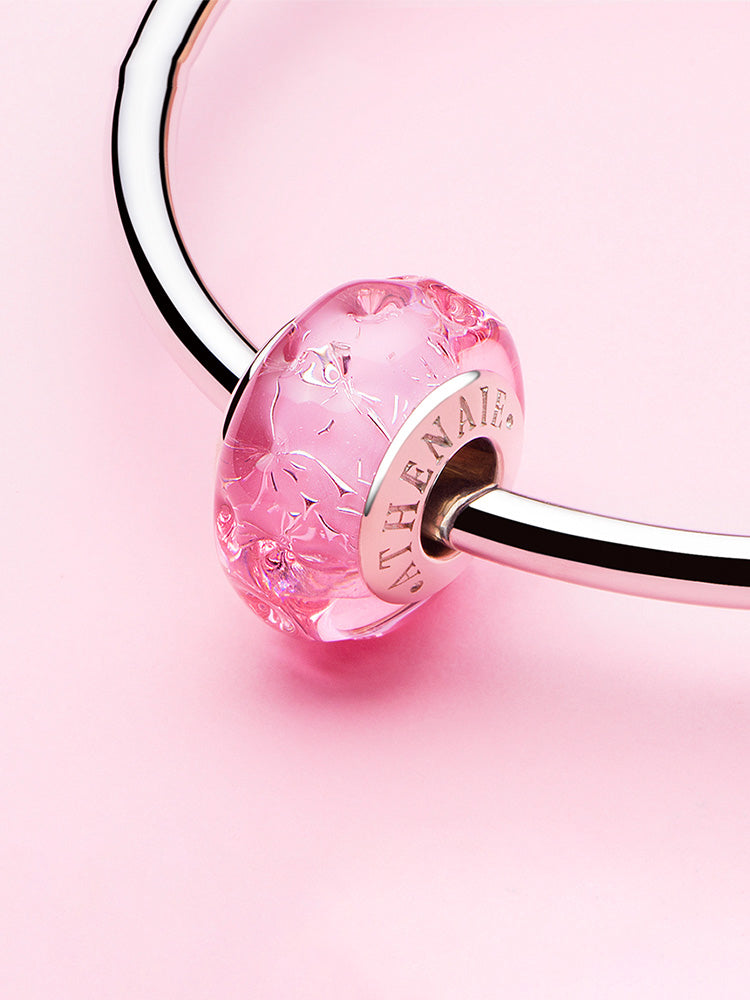 Pink blossom glow murano glass charm bead styled on bracelet