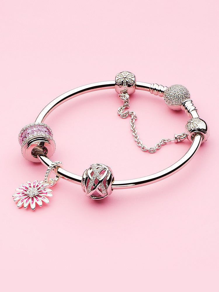Sterling silver pink charm bead styled on charm bracelet