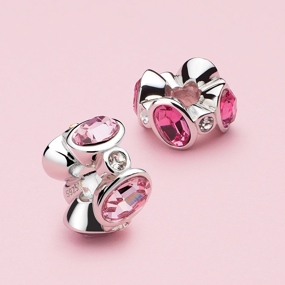 Radiant Rose crystal CZ charm bead displayed in a styled scene.