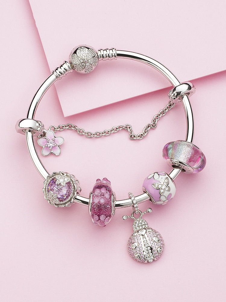 murano glass charm bead styled on bracelet in rainbow colors