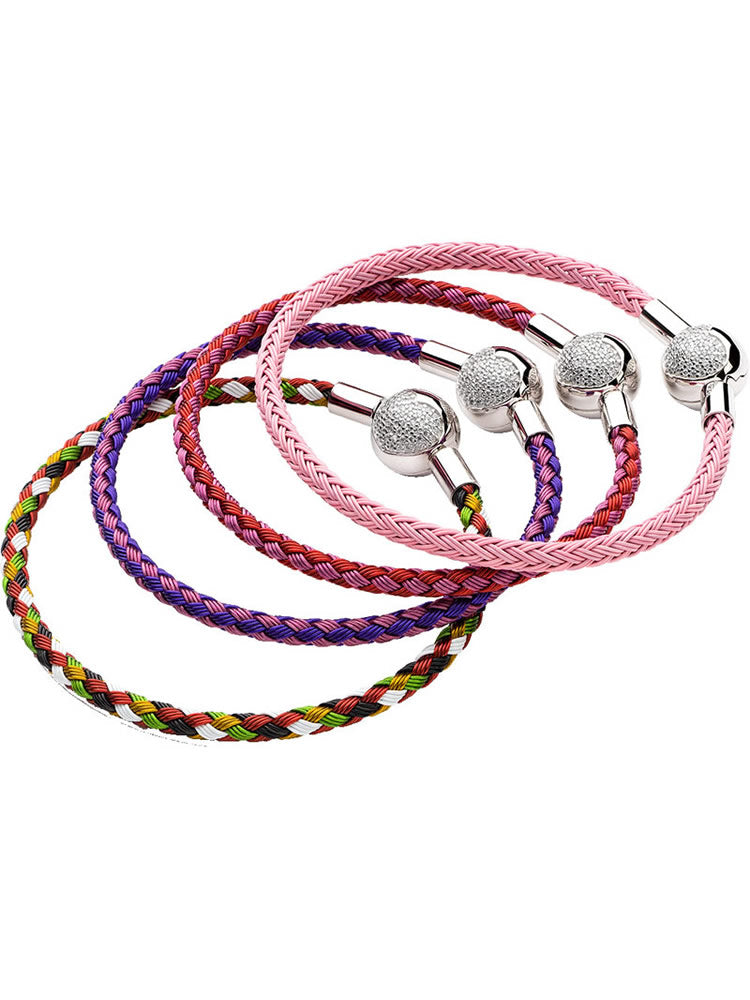 Red and purple braided charm bracelet with sterling silver heart clasp on white background