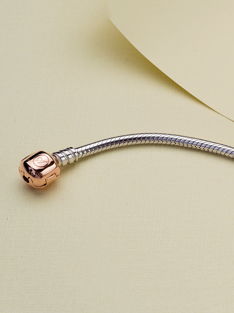 Sterling silver snake chain bracelet with rose gold clasp styling scene