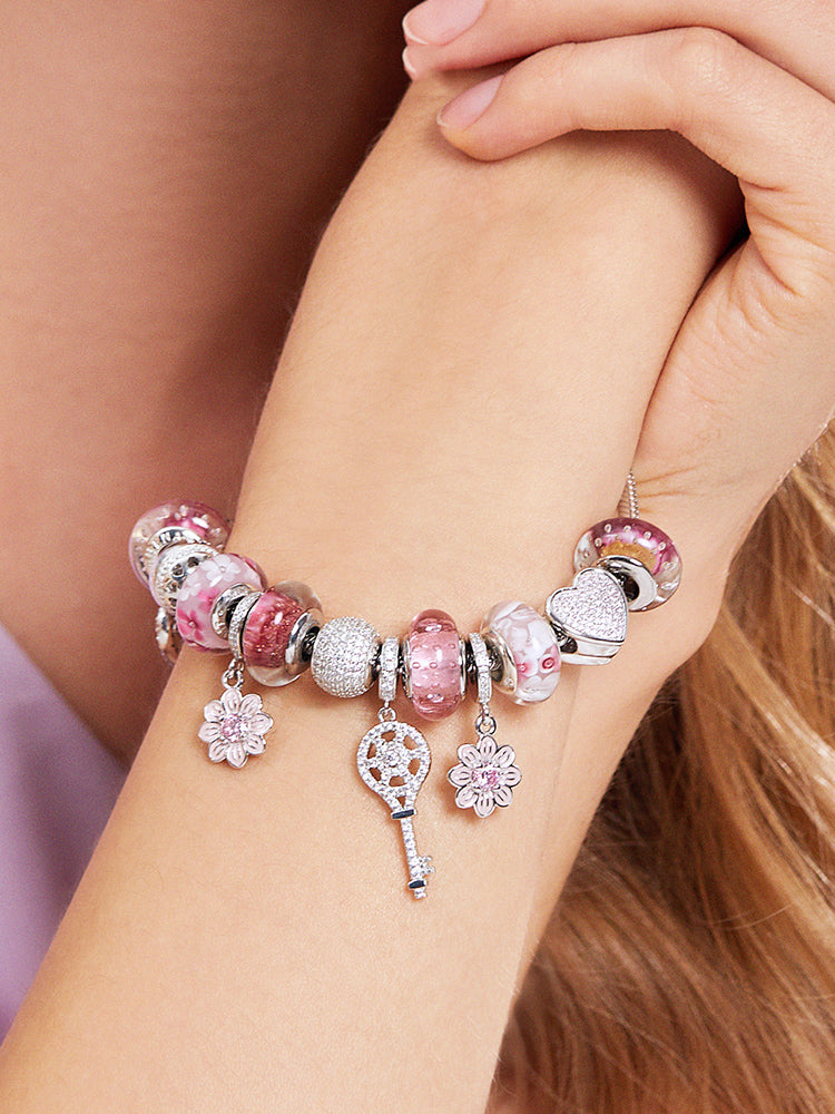 Model wearing rose gold heart charm bead bracelet by ATHENAIE