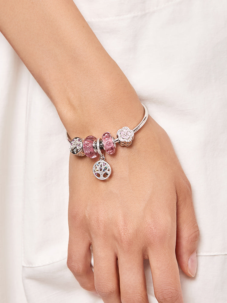 Charm bracelet with the rose pink wave Murano glass bead, worn on the wrist