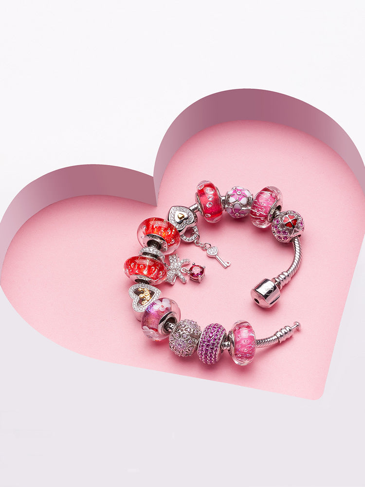 Rosy glow murano glass charm paired with sterling silver charm bracelet