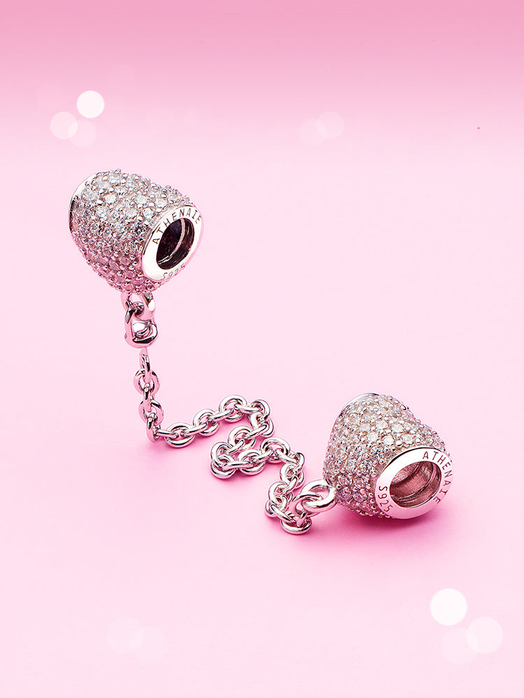 Sterling silver safety chain charm attached to charm bracelet