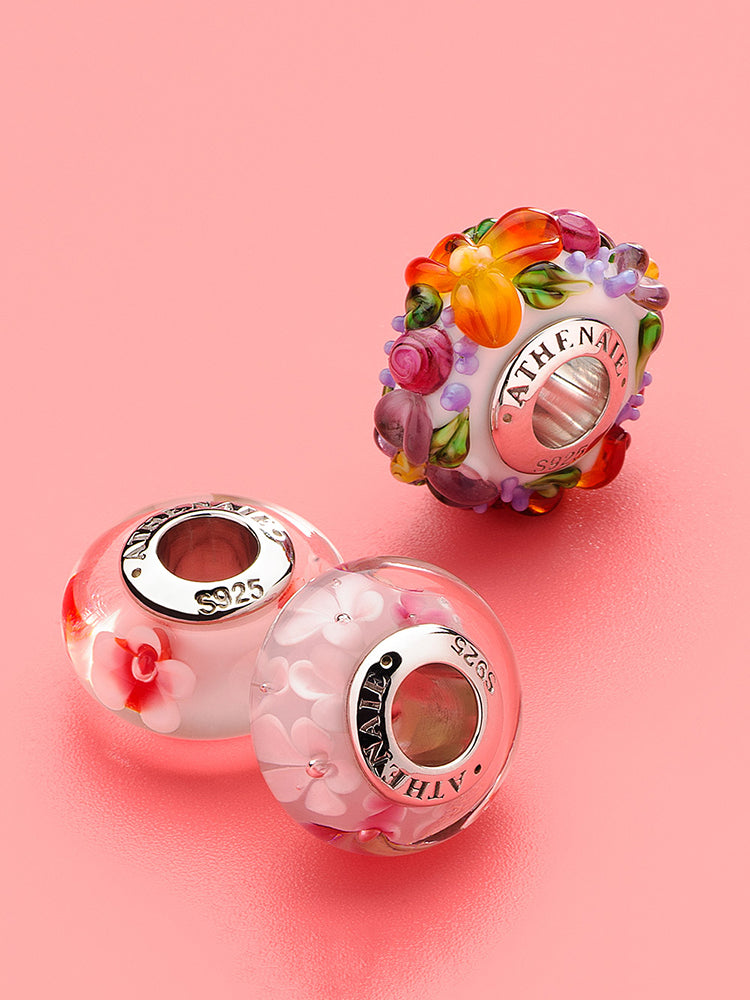Sakura bloom murano glass charm styled on silver charm bracelet