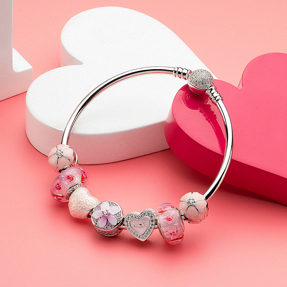 925 silver Sakura lock charm used as bracelet stopper with pastel pink and white enamel flower beads