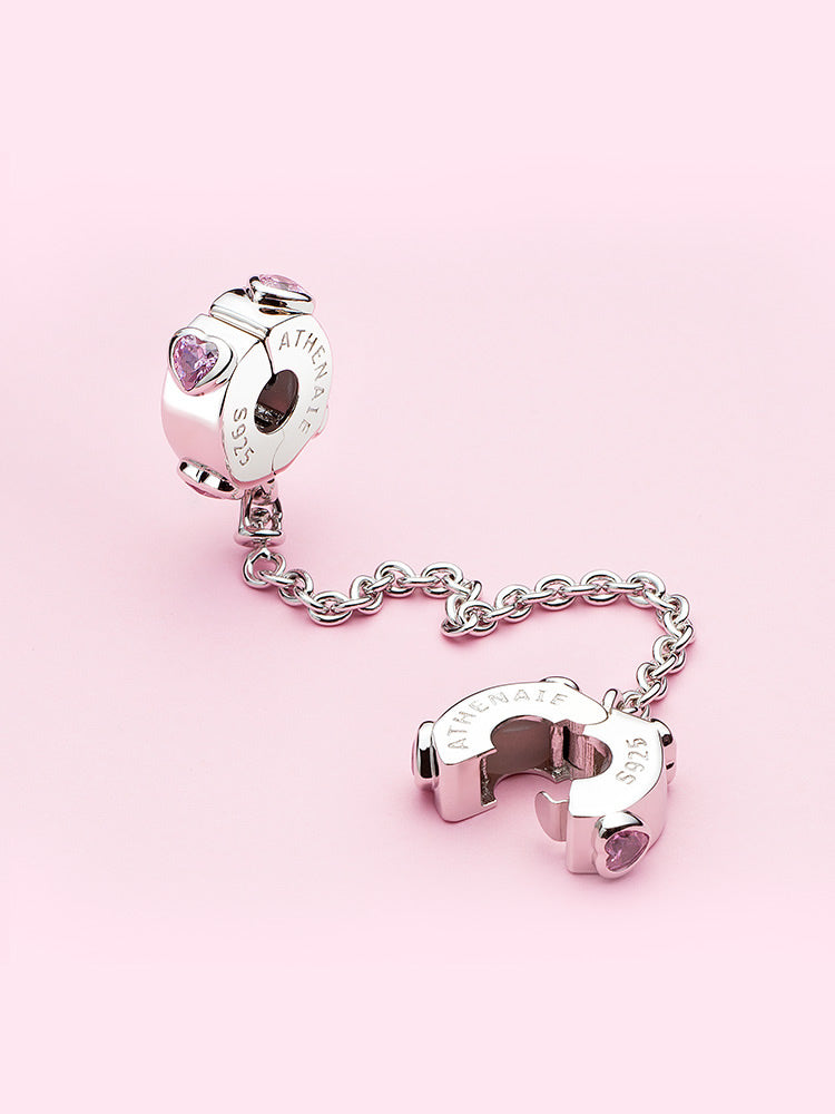 Pink heart safety chain styled on a sterling silver charm bracelet