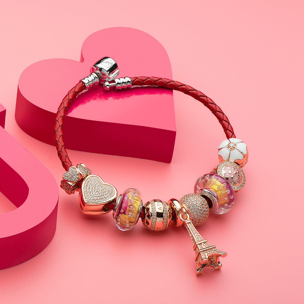 Lifestyle view of Snow Sakura stopper charm with enamel petals and zirconia, symbolizing winter elegance