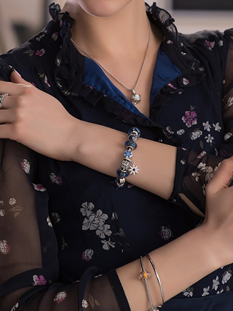 Blue snowflake charm bead bracelet styling on model by ATHENAIE