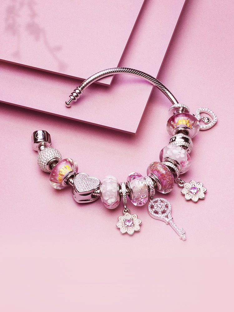 Pink key charm styled on European-style bracelet