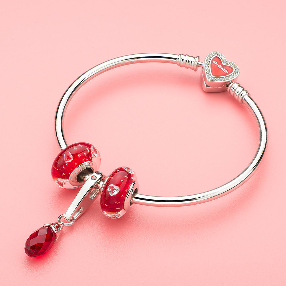 Red crystal charm paired with sterling silver bracelet