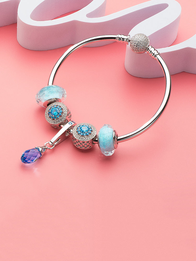 Blue crystal pendant charm paired with bracelet