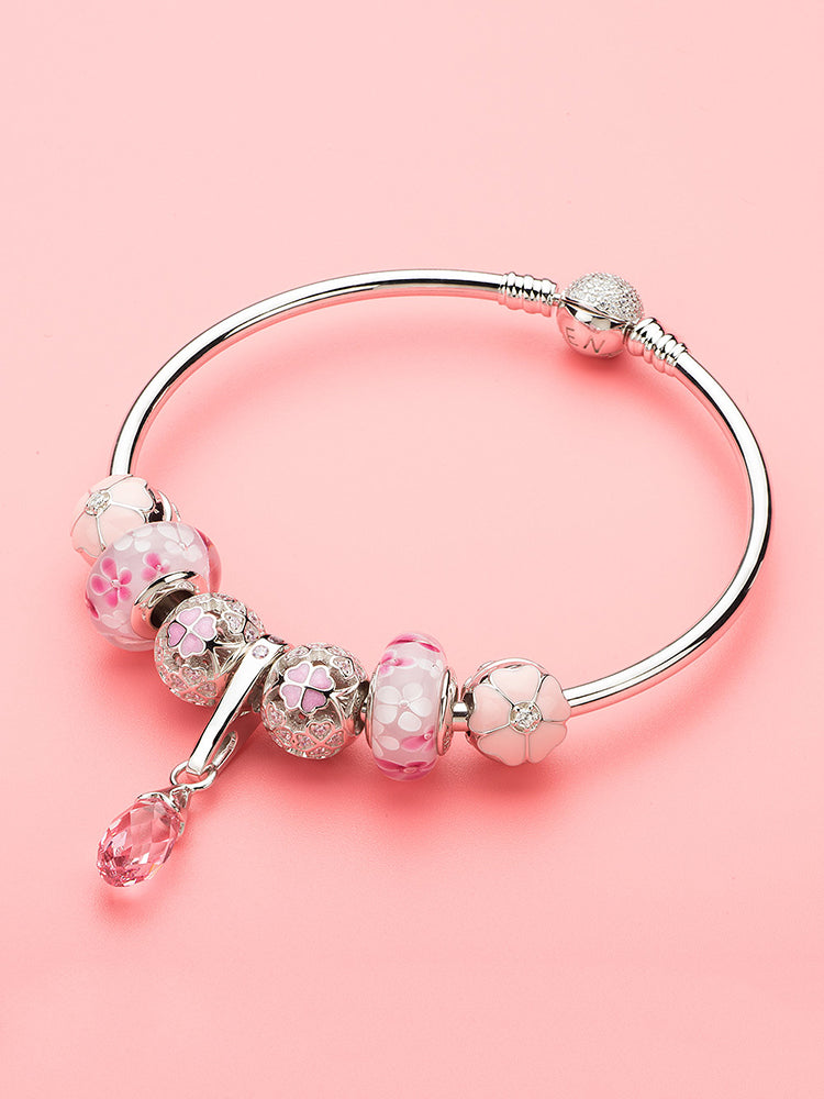 Pink crystal dangle charm in layered bracelet styling