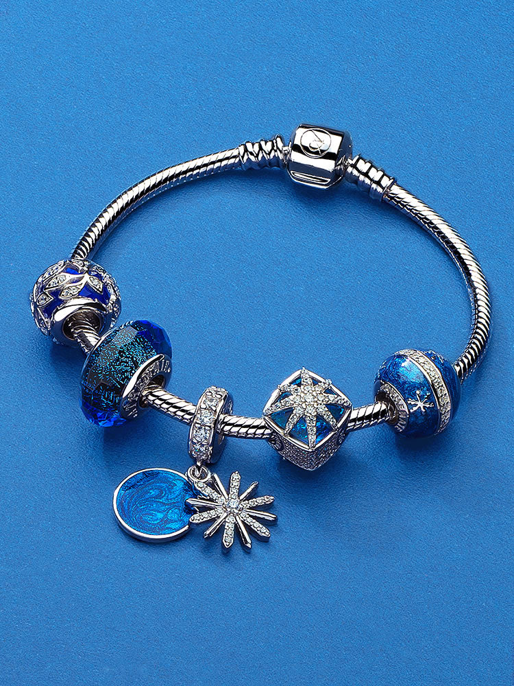 Blue starburst charm bead styled on charm bracelet