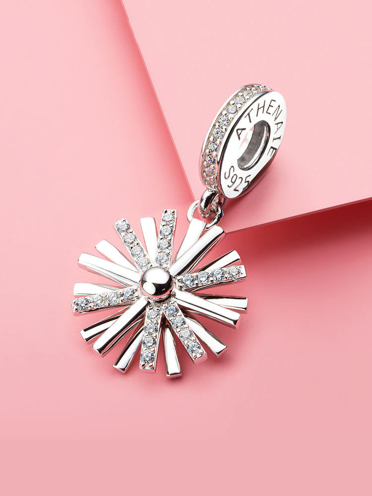 Starburst sterling silver dangle charm styled on bracelet